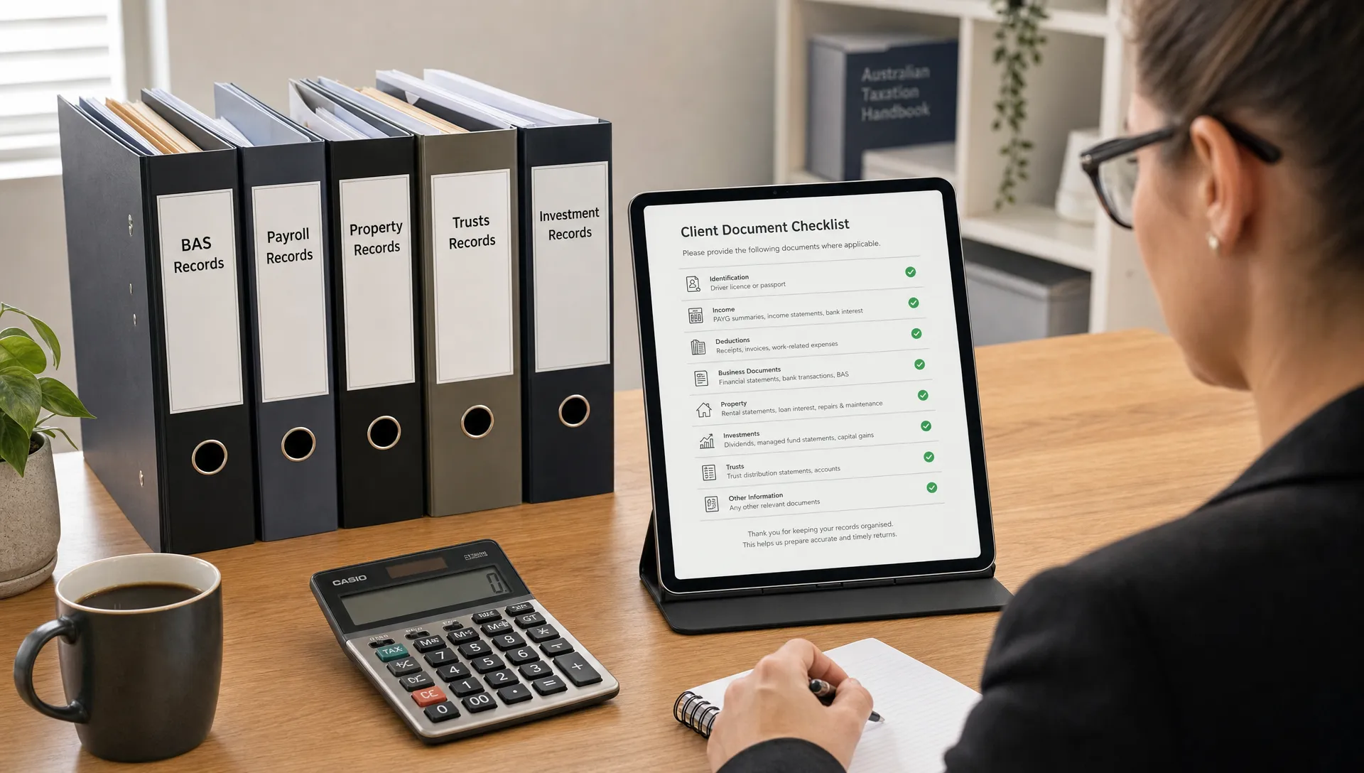 An organised accounting workspace with labelled folders for BAS, payroll, property, trusts and investment records, alongside a tablet showing a clean document checklist facing the accountant.