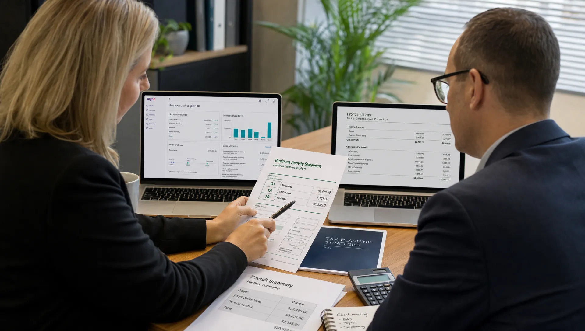 Australian tax advisers review financial reports, BAS and GST documents, payroll summaries and cloud accounting dashboards on laptop screens in a professional office setting.