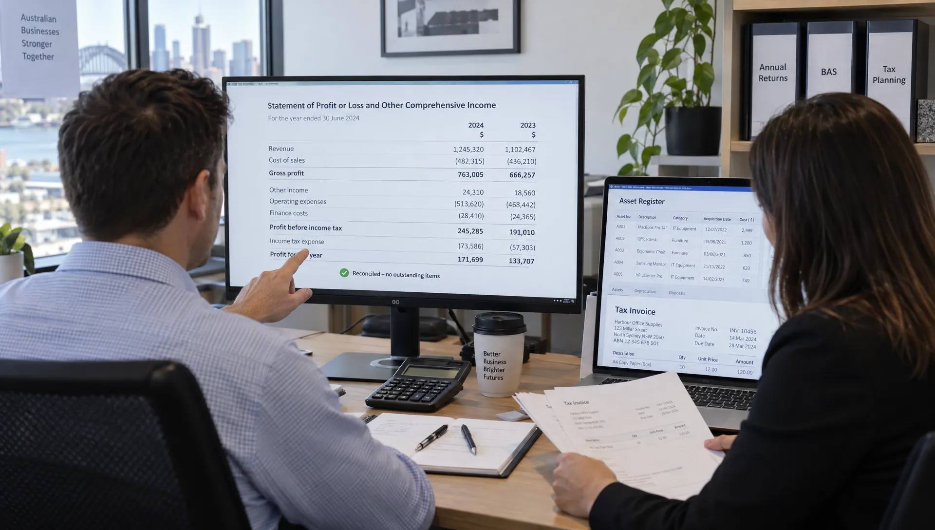 An accountant checks reconciled financial statements while a colleague reviews asset records and invoices for business tax filing services.